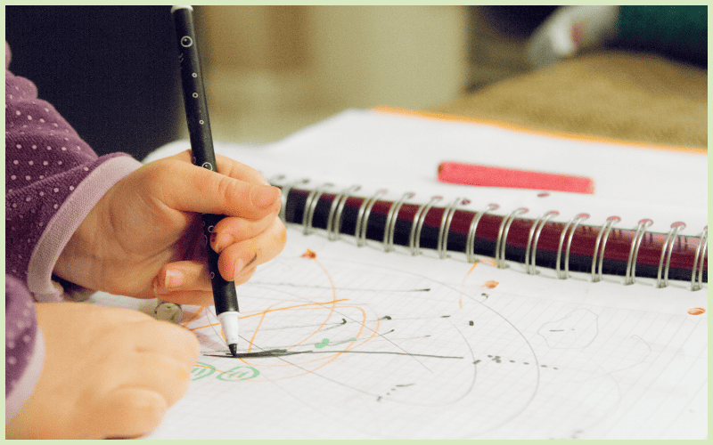 A parent and child sit amidst packed boxes, representing the struggles of eviction.