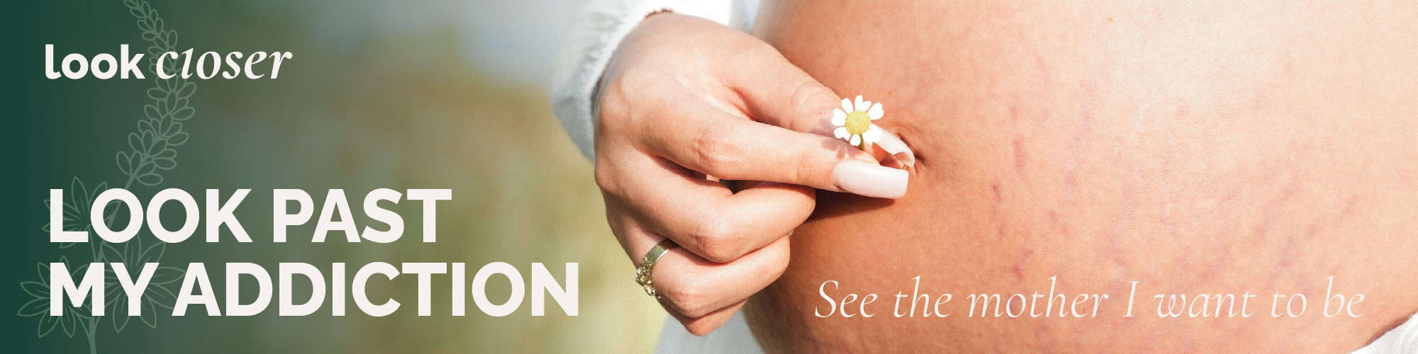 photo of a woman holding a flower against her pregnancy belly