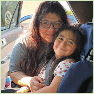 Mother and young daughter embrace